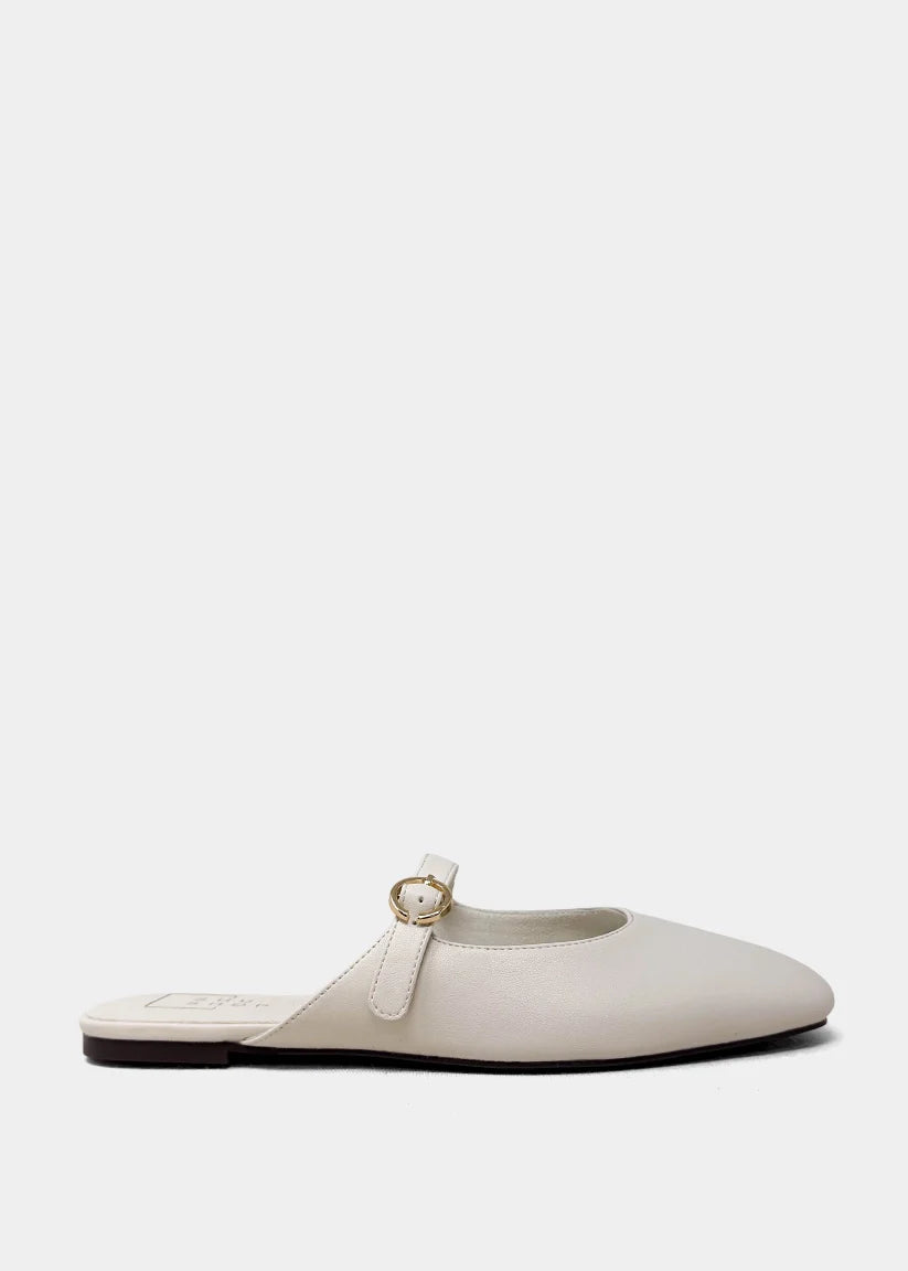 White flat shoe with a strap on a white background
