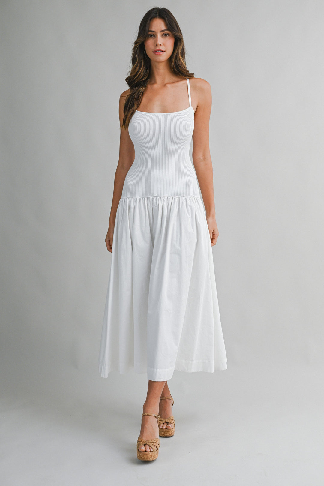 Woman wearing a white dress on a gray background