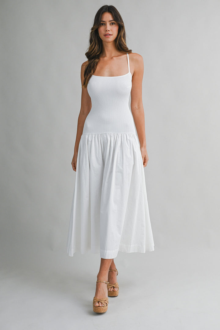 Woman wearing a white dress on a gray background