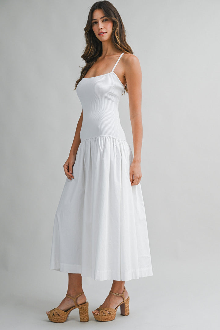 Woman wearing a white dress on a gray background
