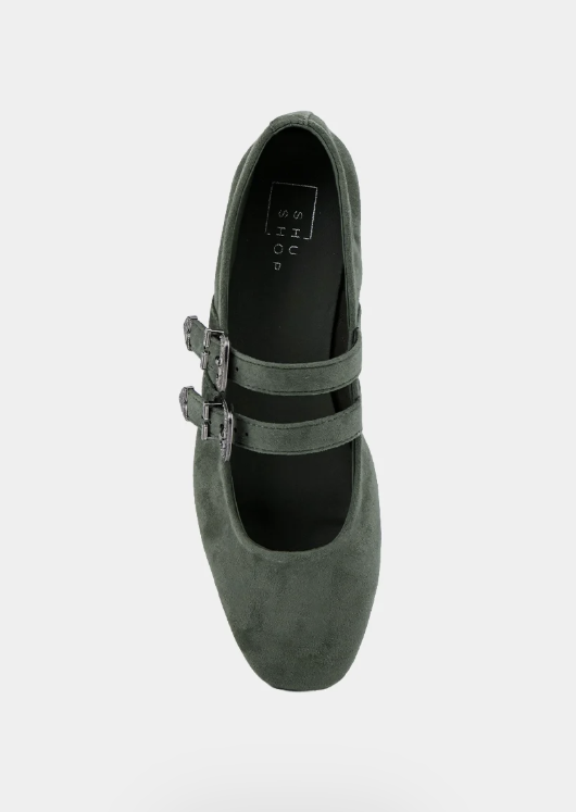A single dark olive green suede Mary Jane flat shoe with double straps and silver buckle details, shown from a top-down view on a light gray background.