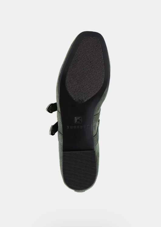 The black sole of a shoe with two buckle straps, showing the brand name &