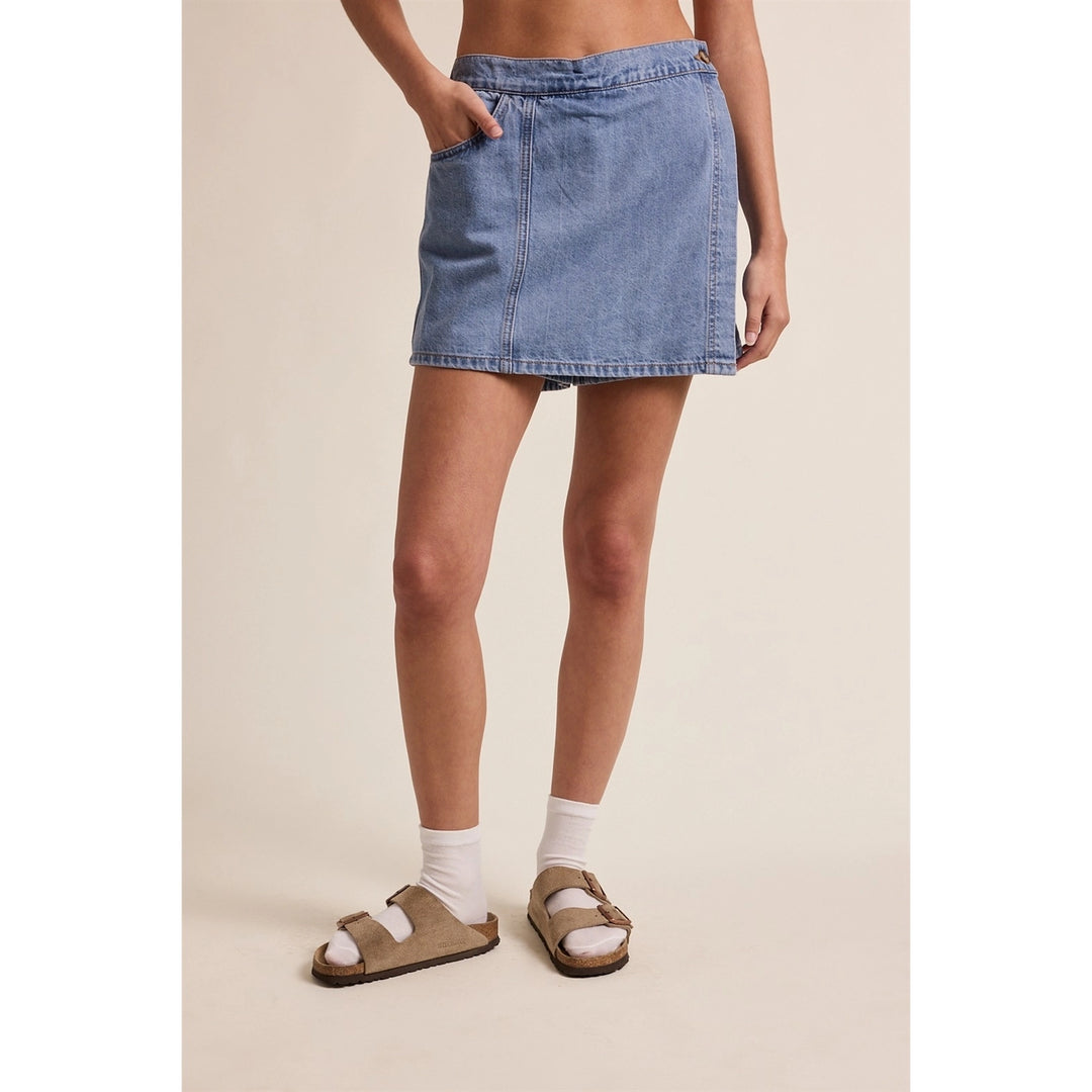 woman wearing denim skort on plain background