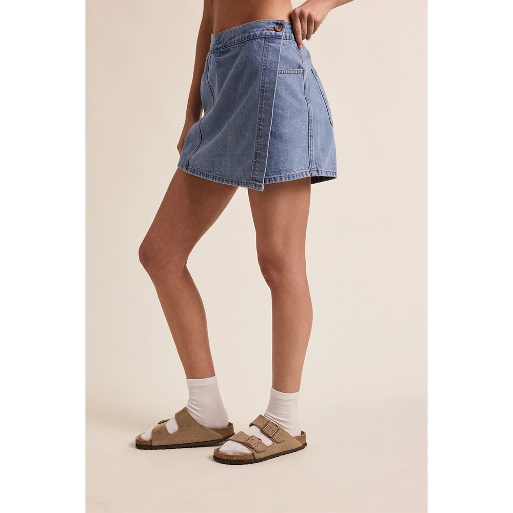 woman wearing denim wrap skort on plain background