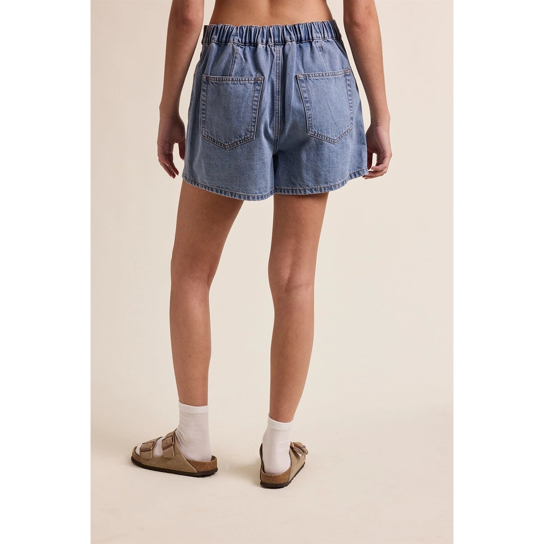 woman wearing denim skort on plain background