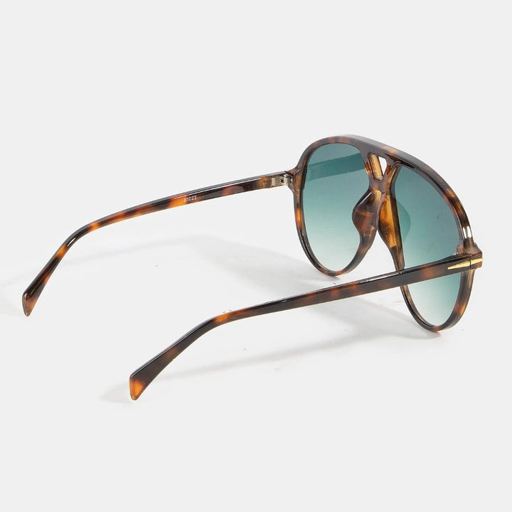 Sunglasses with tortoiseshell frame and green lenses on a white background