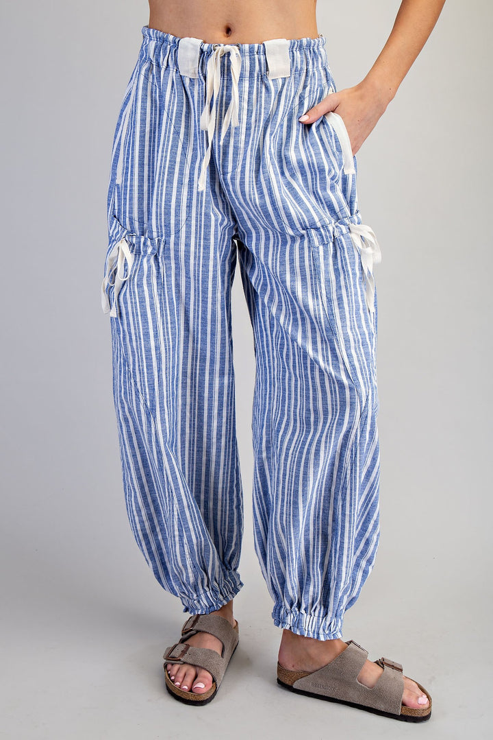 Woman wearing blue stripe pants on plain background