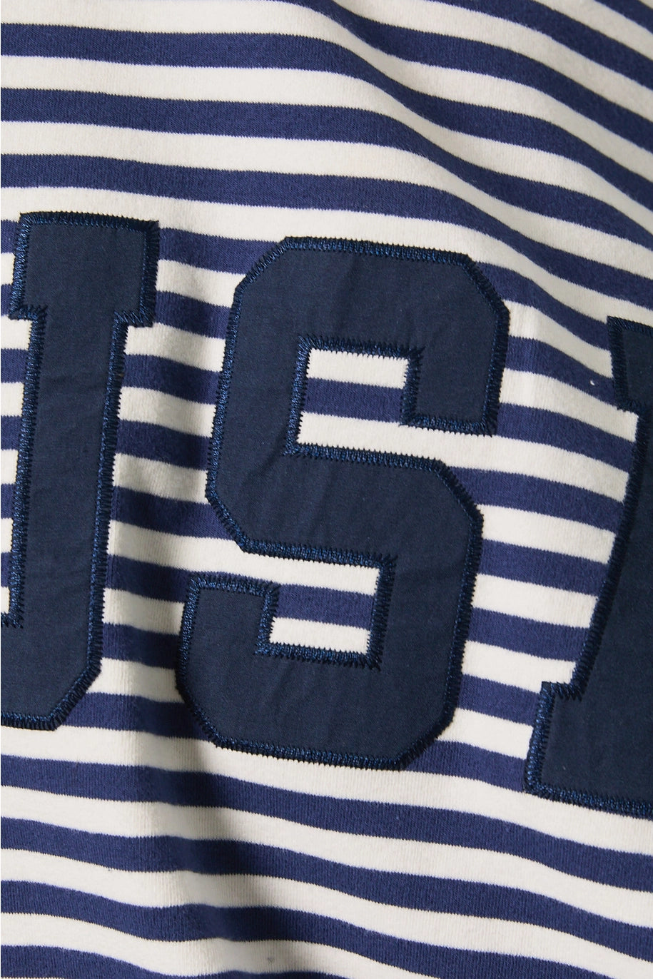 Close-up of a navy and white striped fabric with large letters.