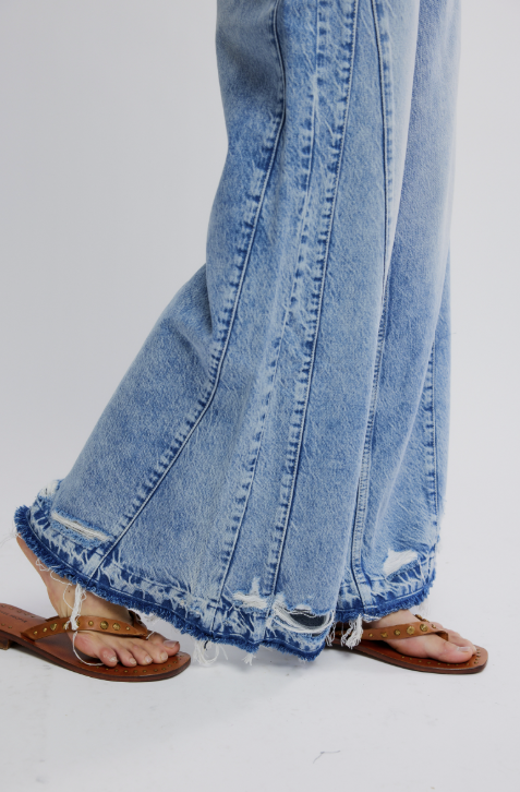 Close-up of blue jeans with a white background