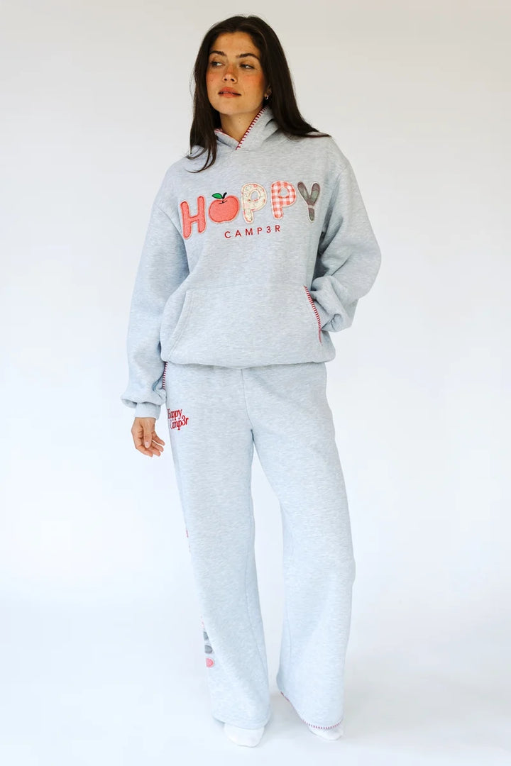 Woman wearing matching heather grey sweatsuit with &