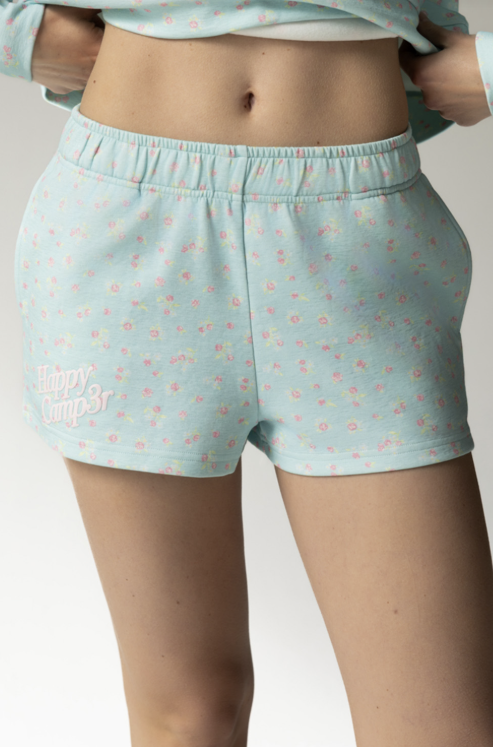 Light blue floral-patterned shorts worn by a person on a plain background