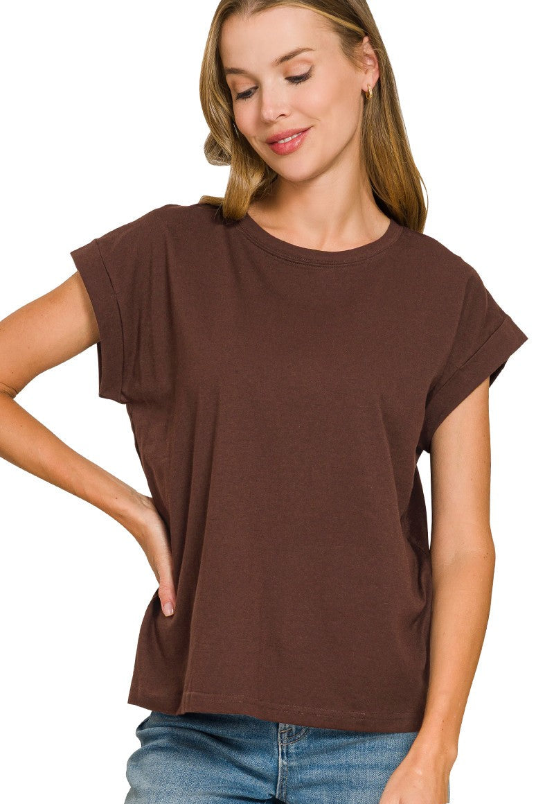 Woman wearing a brown t-shirt and blue jeans on a white background