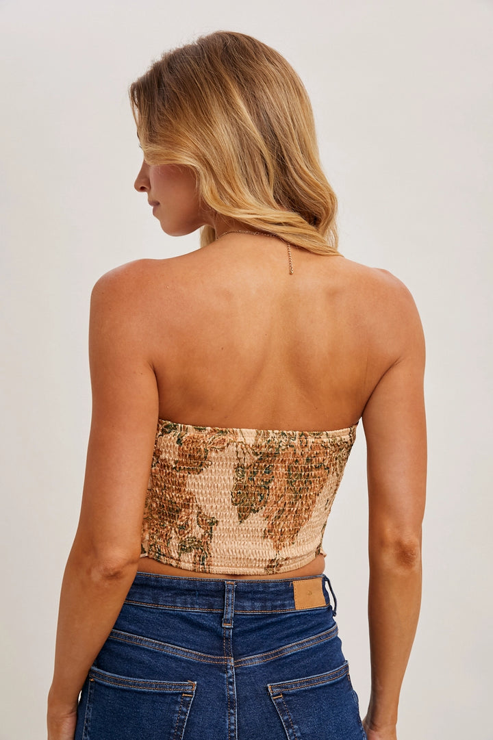 Back of woman wearing peach paisley print tube top on plain background