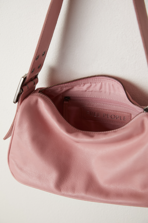 Pink handbag with visible brand name on a light background