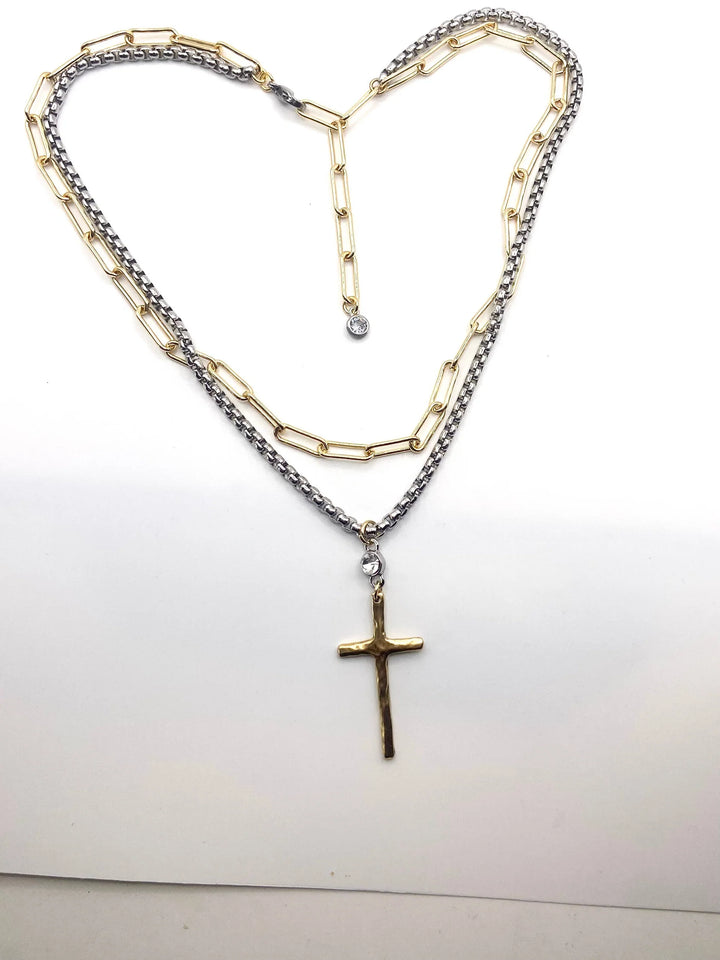 Necklace with a cross pendant shaped into a heart on a white background