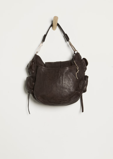 Large espresso brown purse hanging from hook on white background