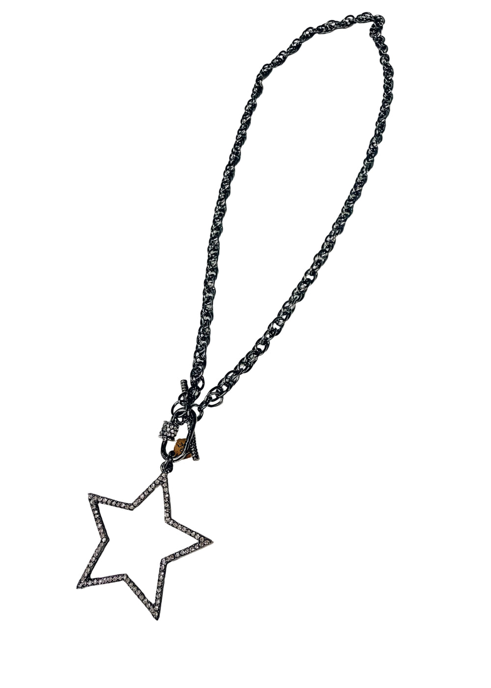 Silver necklace with large star pendant with pave crystals on white background