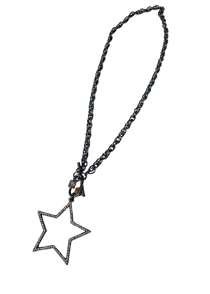 Silver necklace with large star pendant with pave crystals on white background