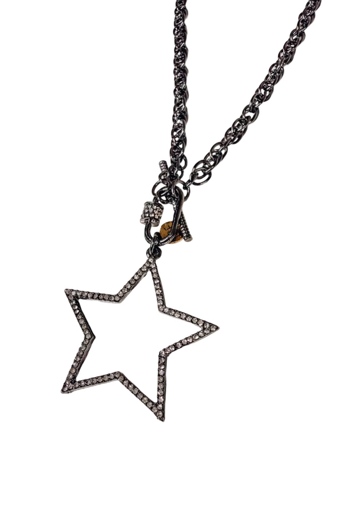 Silver chain necklace with large star pendant with pave crystals on white background