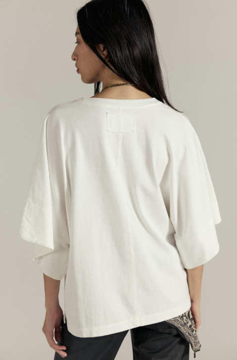 Woman wearing a white blouse with a neutral background
