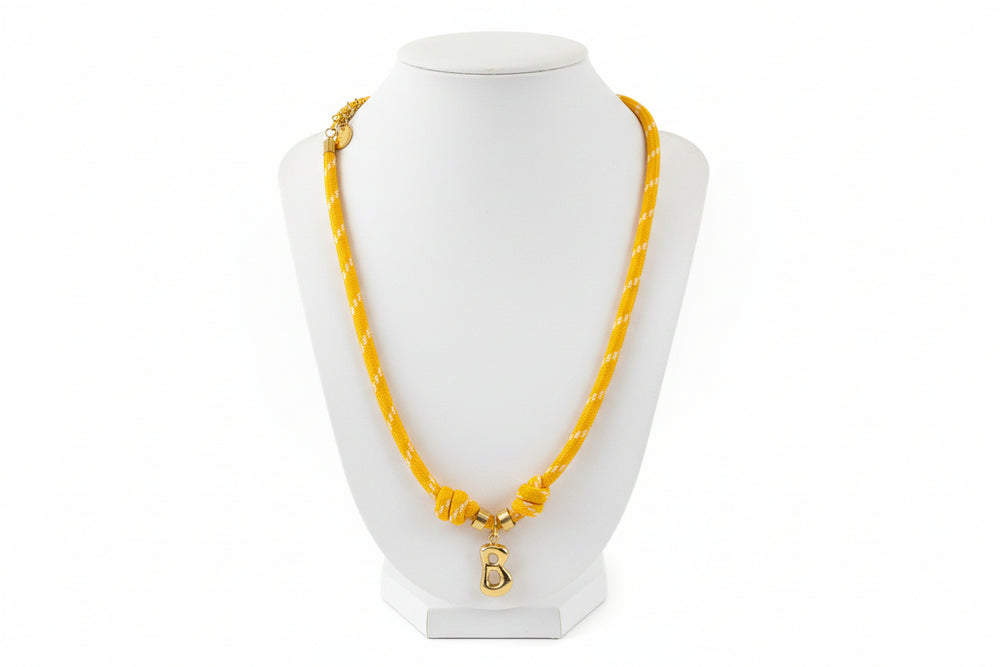 Cord necklace with gold B on white bust