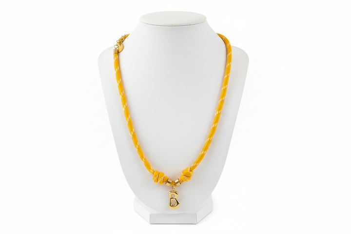 Cord necklace with gold B on white bust