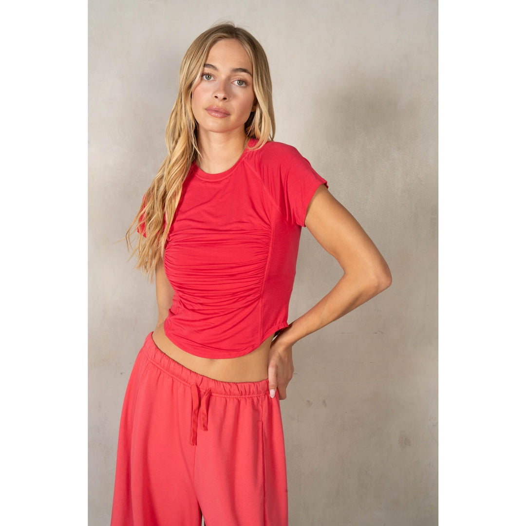 Woman wearing matching set in red on plain background