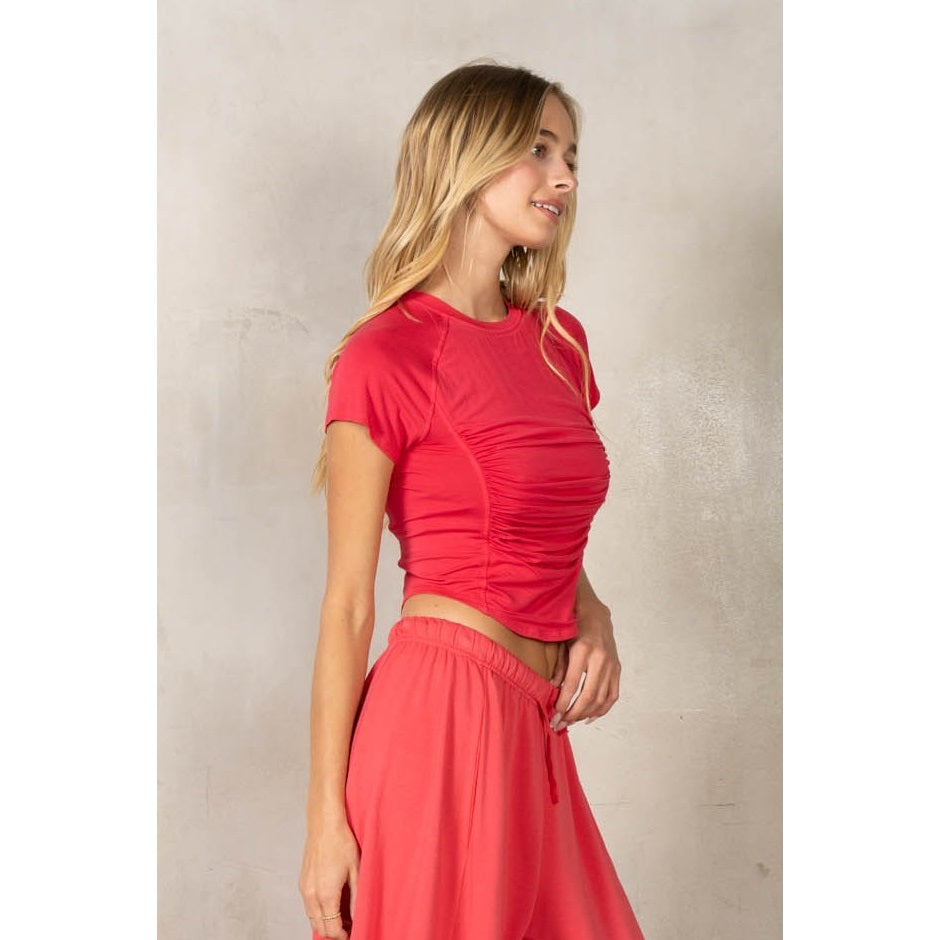 Woman wearing matching set in red on plain background