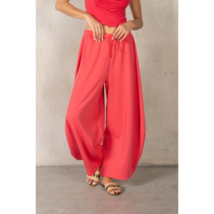 Woman wearing matching red set on plain background