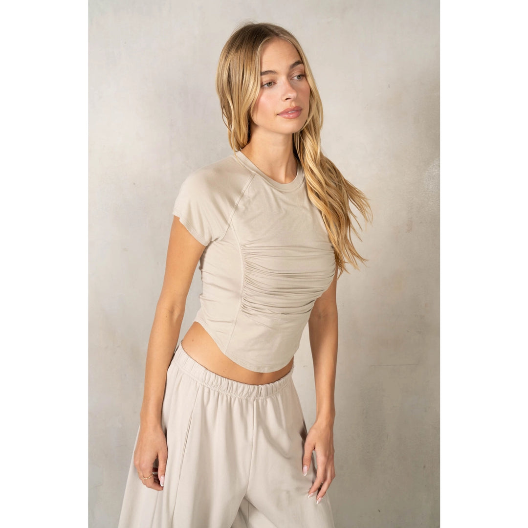 Woman wearing matching beige set on plain background