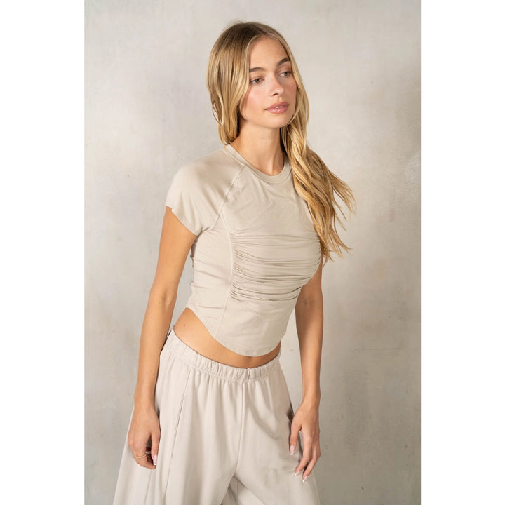 Woman wearing matching beige set on plain background