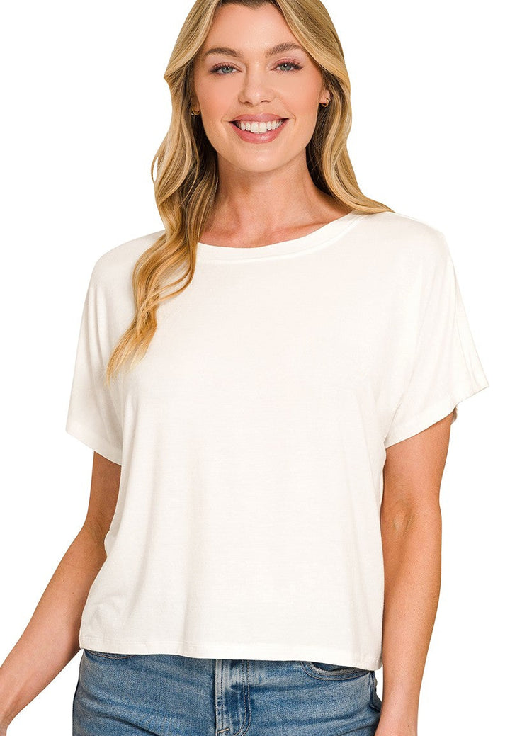 Woman wearing a white t-shirt and blue jeans on a white background