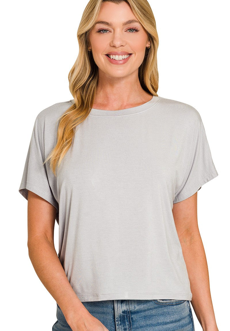 Woman wearing a light gray t-shirt on a white background