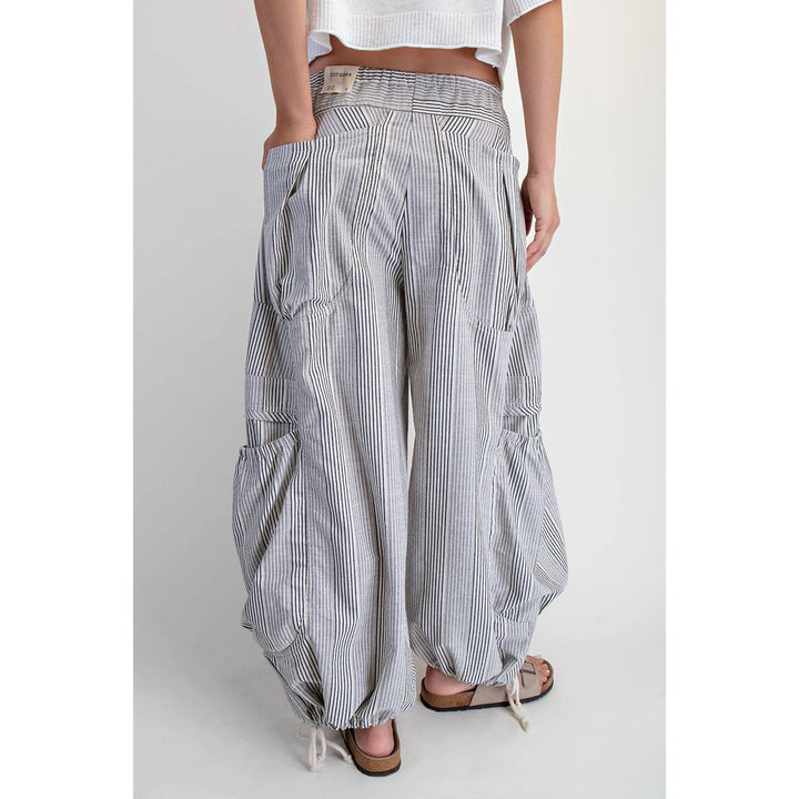 Person wearing striped wide-leg pants on a white background
