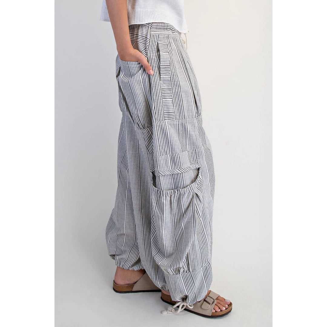 Person wearing wide-leg striped pants on a plain background