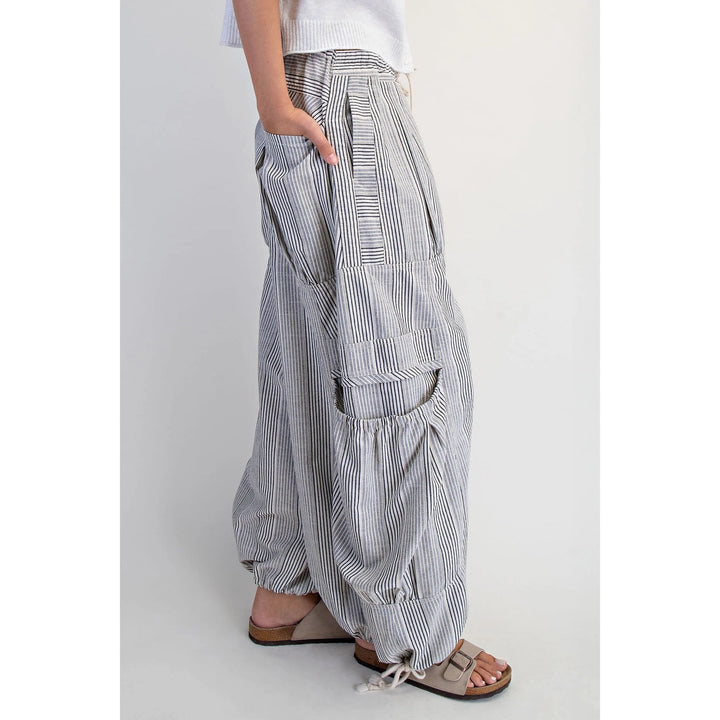Person wearing wide-leg striped pants on a plain background