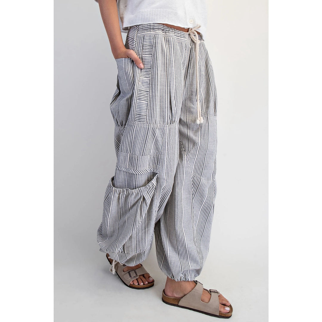 Striped harem pants worn by a person on a plain background