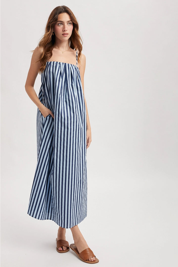 Woman wearing a blue and white striped dress on a white background