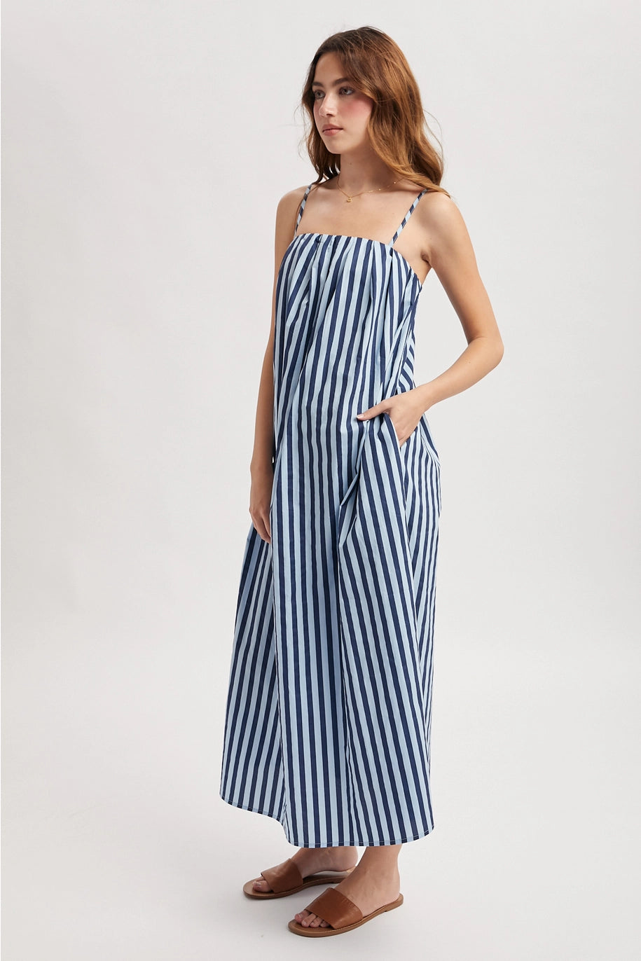 Woman wearing blue dress on plain background