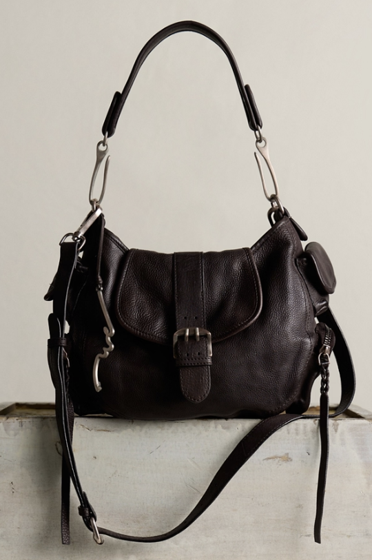Dark brown leather handbag with a strap on a light gray background