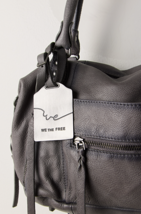 Grey purse with tag that states &