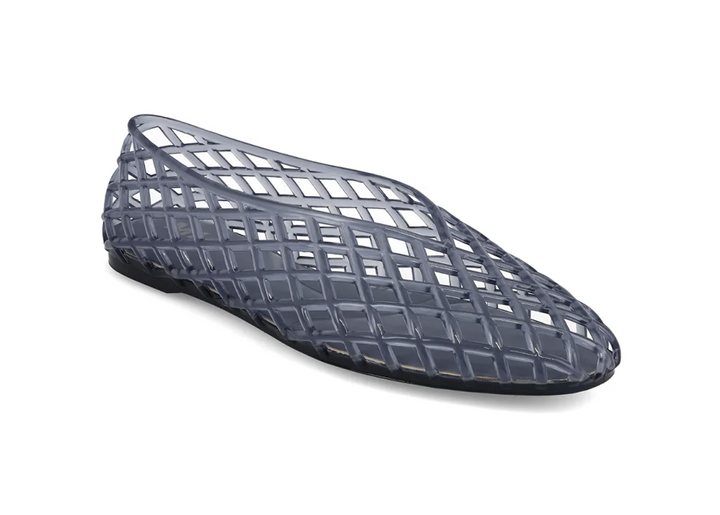 A single dark gray translucent jelly shoe with a grid-patterned cutout design, shown from a side profile on a white background.