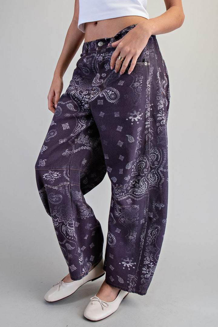Person wearing purple patterned pants on a plain background