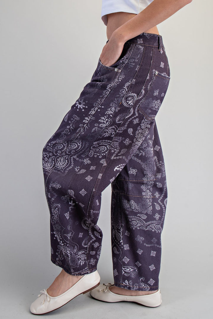 Person wearing purple patterned pants on a plain background