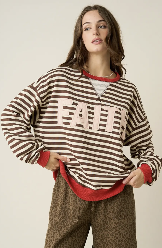 A woman modeling a brown and beige striped long-sleeve sweatshirt with &
