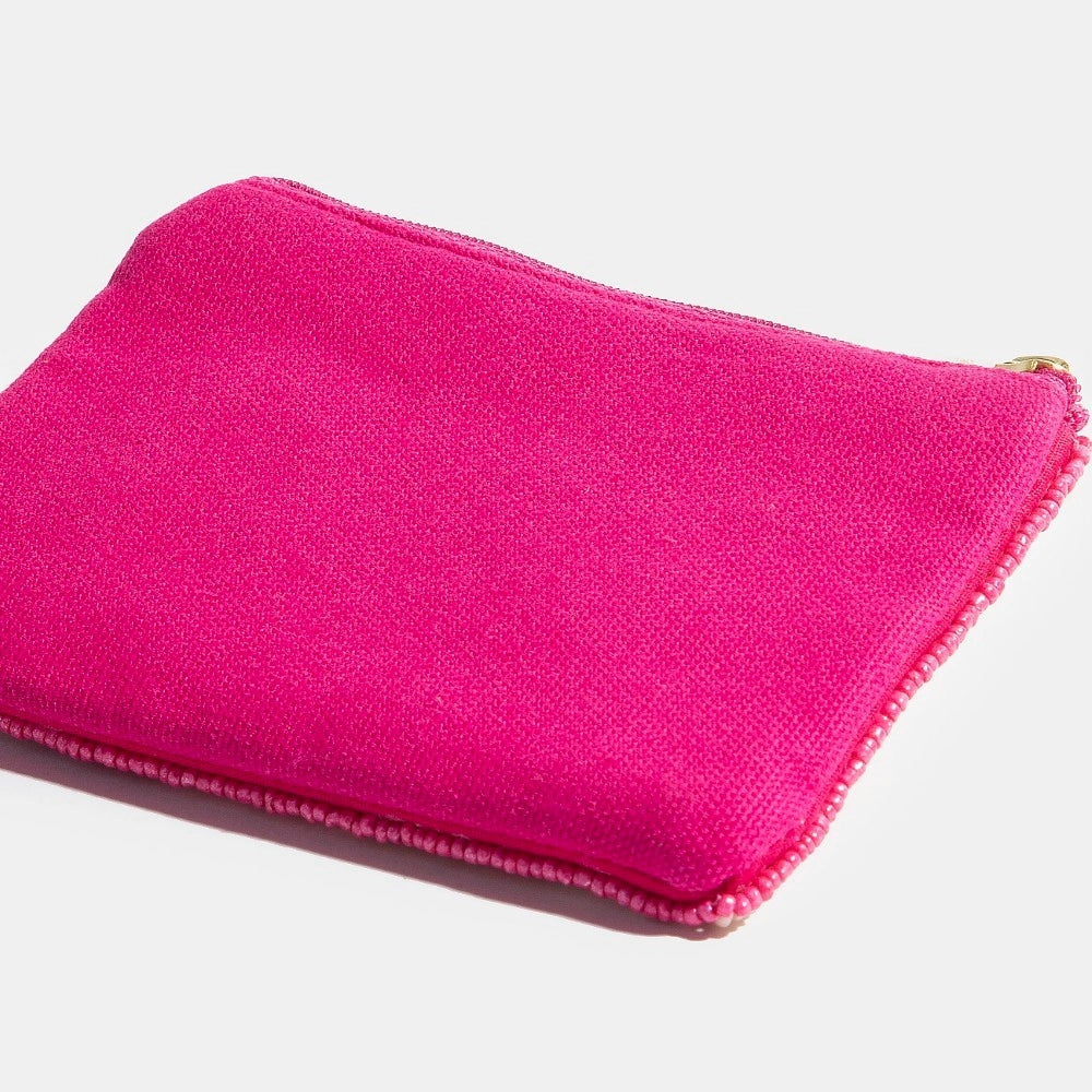 Pink pouch with a gold zipper on a light gray background