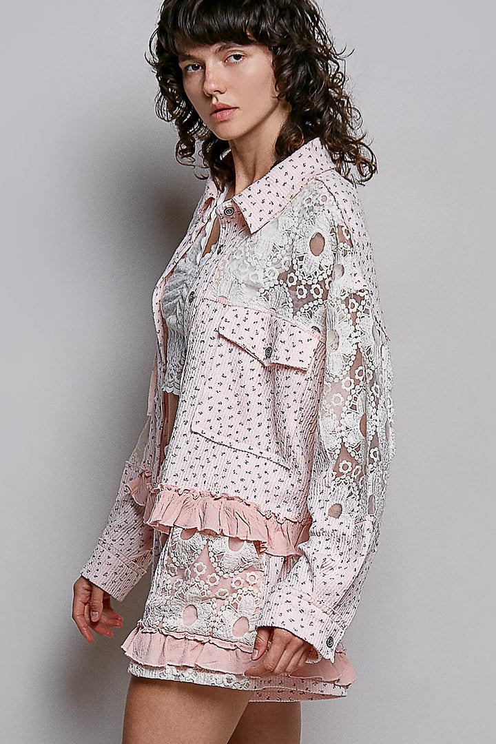 Woman wearing a floral dress with ruffled layers against a plain background