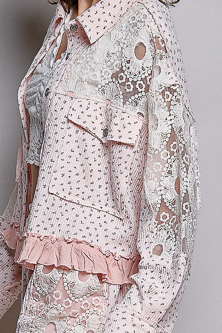 Lace dress with floral patterns and ruffles on a plain background