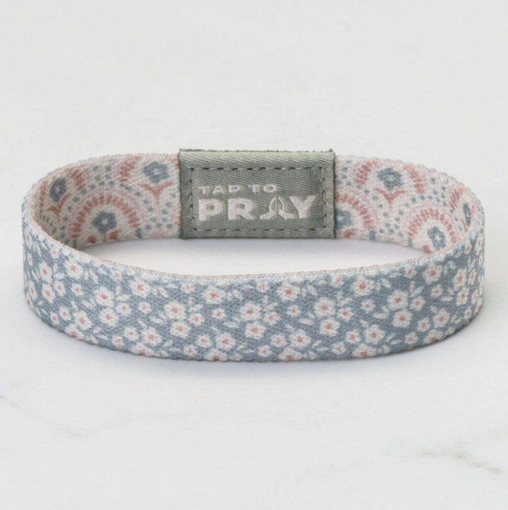 Floral patterned bracelet with a gray tag on a white background
