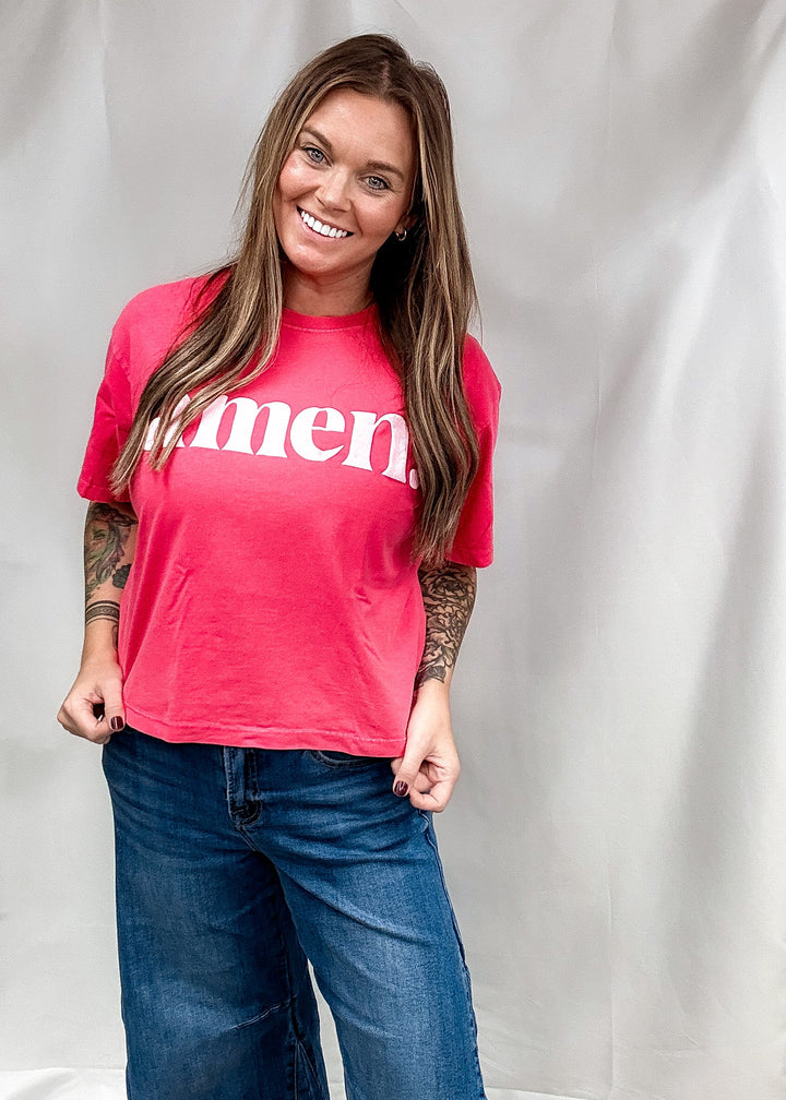 Woman wearing red shirt that says &